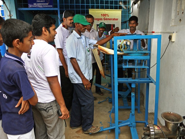 EGP staff demonstrate the arakia nut leaf press